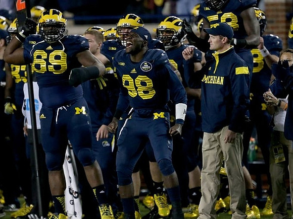 Willie Henry (69) and Devin Gardner (98)