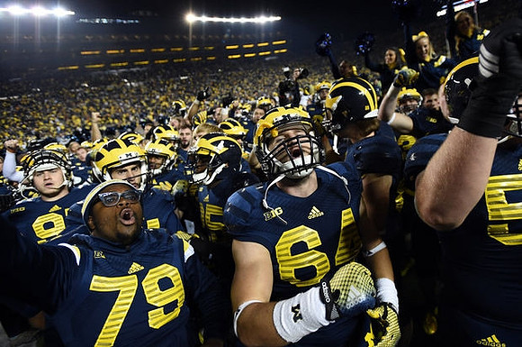 Michael Wroblewski (64) and Michigan Team