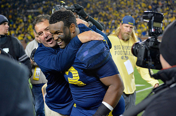 Brady Hoke, Mario Ojemudia (53), and Steve Everitt