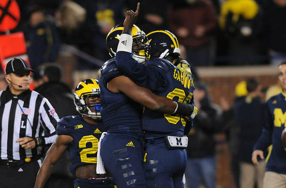 Dennis Norfleet (23) and Devin Gardner (98)