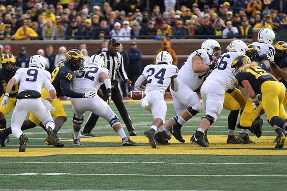 Devin Bush (10), Kwity Paye (19), and Chase Winovich (15)