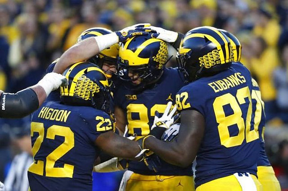 Karan Higdon (22), Zach Gentry (83), and Nick Eubanks (82)