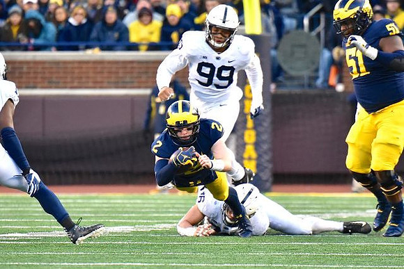 Shea Patterson (2) and Cesar Ruiz (51)