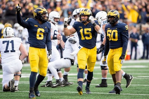Josh Uche (6), Chase Winovich (15), and Michael Dwumfour (50)