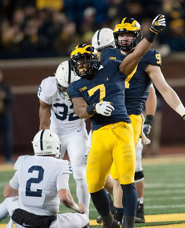 Khaleke Hudson (7) and Aidan Hutchinson (97)