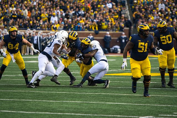 Sean McKeon (84), Karan Higdon (22), Cesar Ruiz (51), and Michael Onwenu (50)