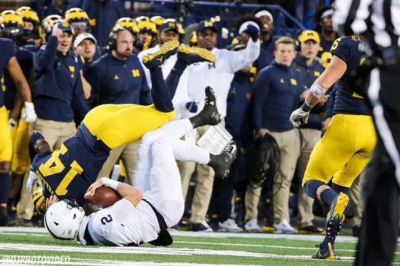 Josh Metellus (14) and Chase Winovich (15)