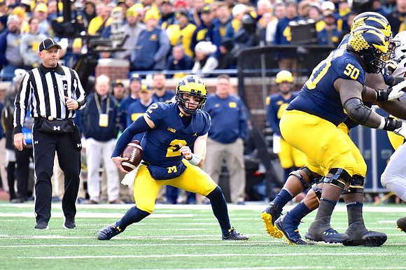 Shea Patterson (2) and Michael Onwenu (50)