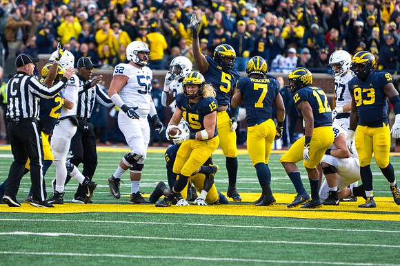 Tyree Kinnel (23), Chase Winovich (15), Aubrey Solomon (5), Khaleke Hudson (7), Josh Ross (12), and Lawrence Marshall (93)
