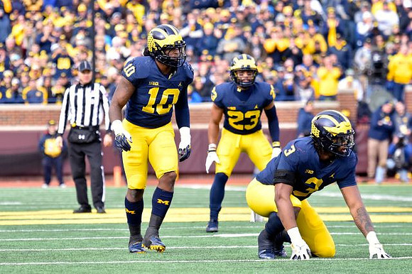 Devin Bush (10), Tyree Kinnel (23), and Rashan Gary (3)