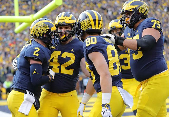 Shea Patterson (2), Ben Mason (42), Oliver Martin (80), Zach Gentry (83), and Jon Runyan Jr. (75)