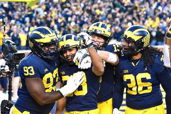 Lawrence Marshall (93), Brandon Watson (28), Chase Winovich (15), and Devin Gil (36)