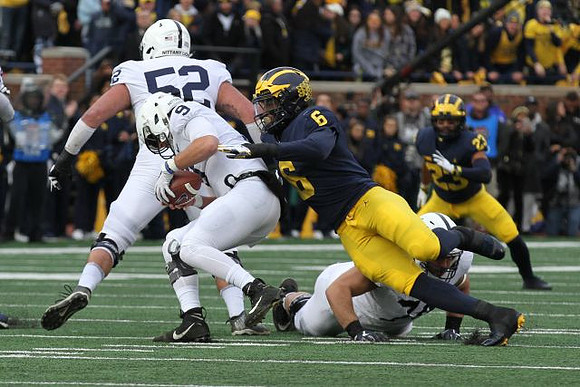 Josh Uche (6) and Tyree Kinnel (23)
