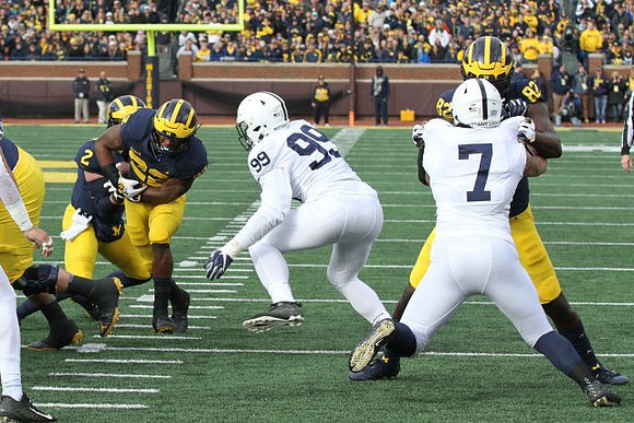 Shea Patterson (2), Karan Higdon (22), and Nick Eubanks (82)