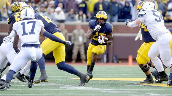 Michael Onwenu (50), Karan Higdon (22), and Ben Bredeson (74)