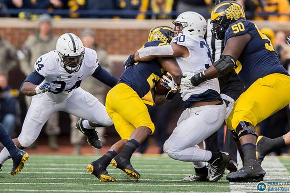 Karan Higdon (22) and Michael Onwenu (50)