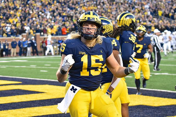 Chase Winovich (15), Lavert Hill (24), Devin Gil (36), and Khaleke Hudson (7)