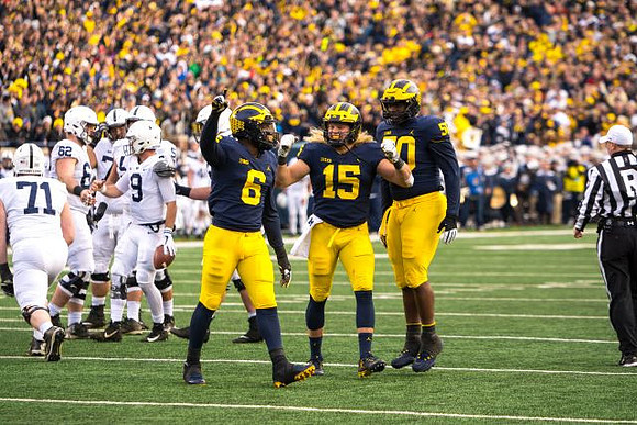 Josh Uche (6), Chase Winovich (15), and Michael Dwumfour (50)
