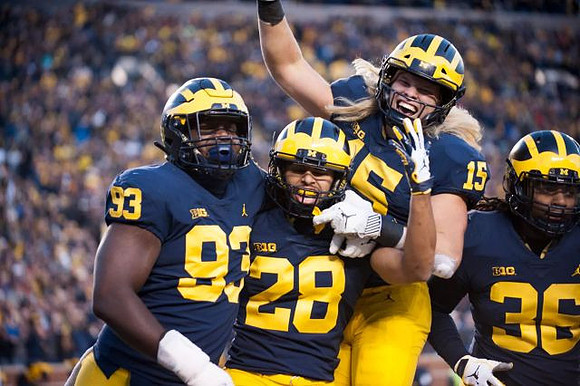 Lawrence Marshall (93), Brandon Watson (28), Chase Winovich (15), and Devin Gil (36)