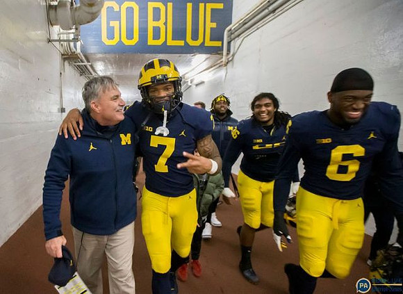 Don Brown, Khaleke Hudson (7), and Josh Uche (6)