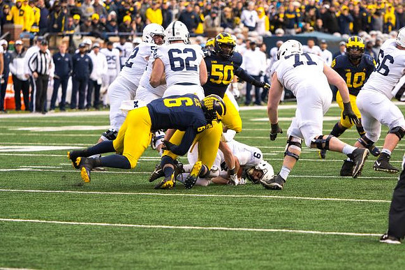 Josh Uche (6), Michael Dwumfour (50), and Devin Bush (10)