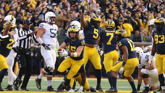 Tyree Kinnel (23), Chase Winovich (15), Aubrey Solomon (5), Khaleke Hudson (7), Josh Ross (12), and Lawrence Marshall (93)