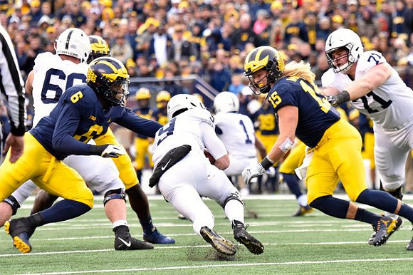 Josh Uche (6) and Chase Winovich (15)