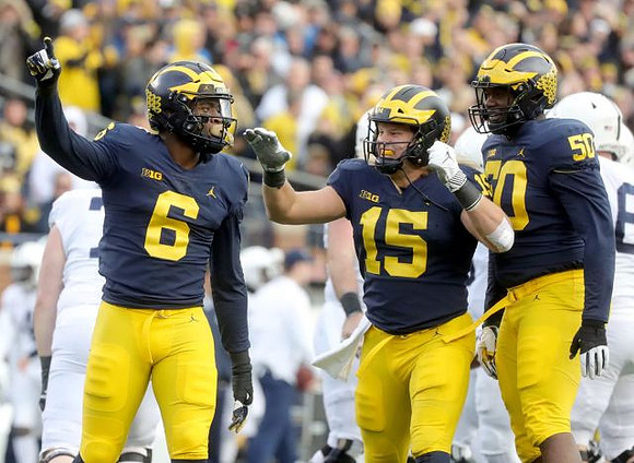 Josh Uche (6), Chase Winovich (15), and Michael Dwumfour (50)