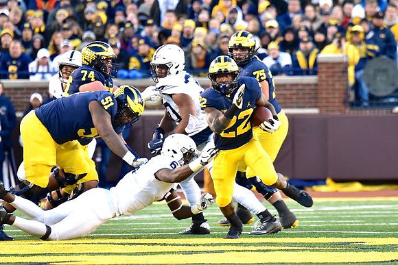 Ben Bredeson (74), Cesar Ruiz (51), Karan Higdon (22), and Jon Runyan Jr. (75)