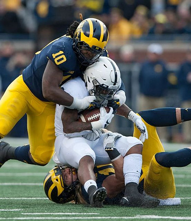 Devin Bush (10) and Chase Winovich (15)