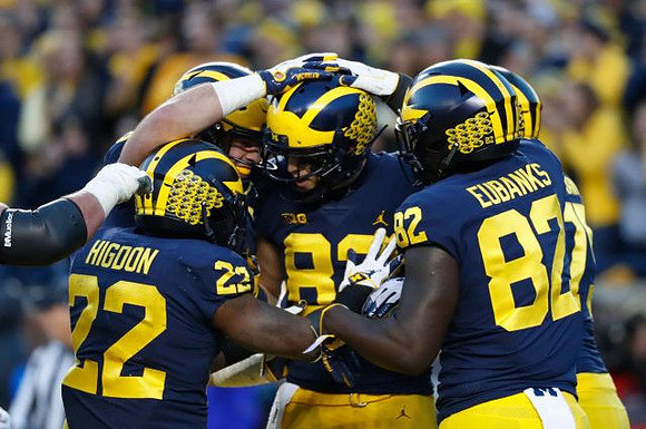 Karan Higdon (22), Zach Gentry (83), and Nick Eubanks (82)