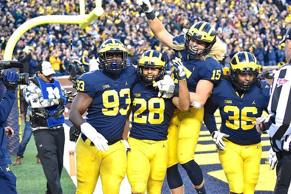 Lawrence Marshall (93), Brandon Watson (28), Chase Winovich (15), and Devin Gil (36)