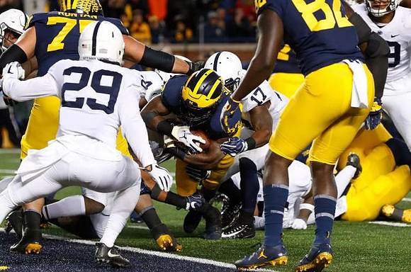 Jon Runyan Jr. (75), Karan Higdon (22), and Nick Eubanks (82)