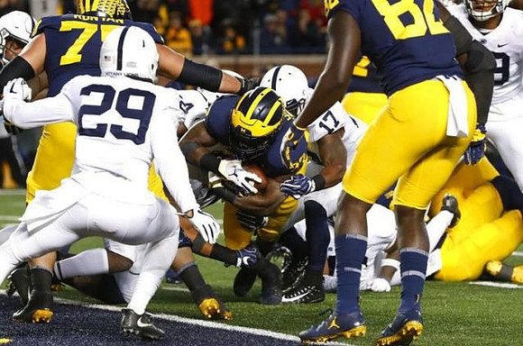 Jon Runyan Jr. (75), Karan Higdon (22), and Nick Eubanks (82)