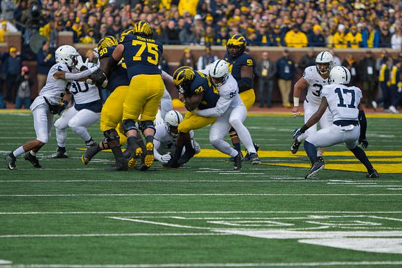 Michael Onwenu (50), Jon Runyan Jr. (75), Karan Higdon (22), and Cesar Ruiz (51)