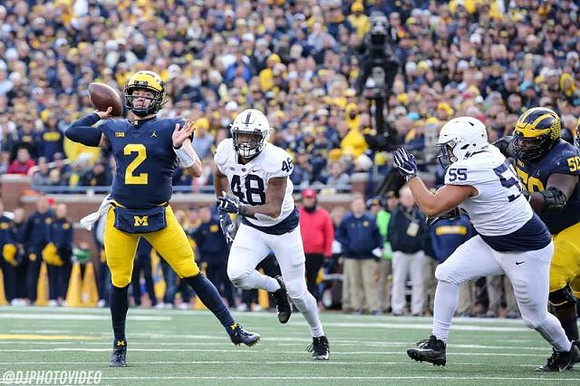 Shea Patterson (2) and Michael Onwenu (50)