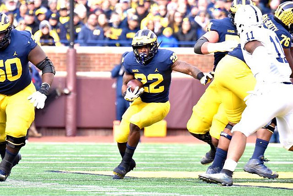 Michael Onwenu (50), Karan Higdon (22), Ben Bredeson (74), and Juwann Bushell-Beatty (76)