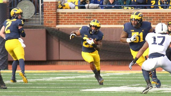 Shea Patterson (2), Karan Higdon (22), and Cesar Ruiz (51)