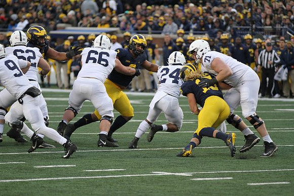 Carlo Kemp (2) and Chase Winovich (15)