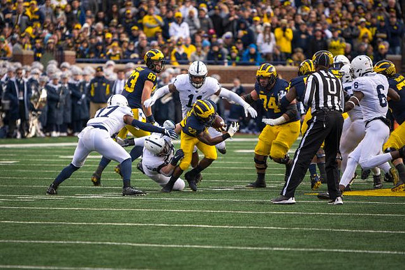 Zach Gentry (83), Karan Higdon (22), and Ben Bredeson (74)