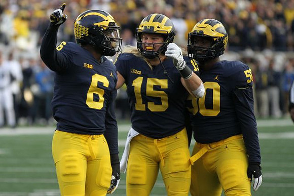 Josh Uche (6), Chase Winovich (15), and Michael Dwumfour (50)