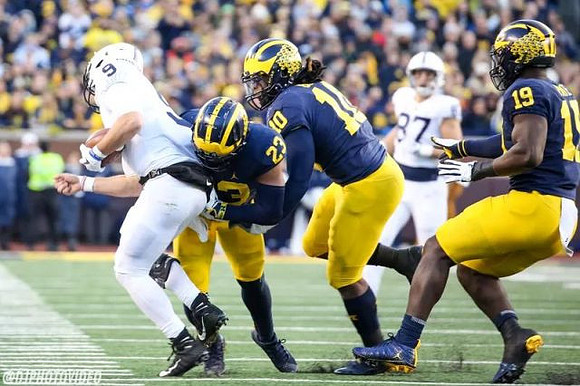 Tyree Kinnel (23), Devin Bush (10), and Kwity Paye (19)