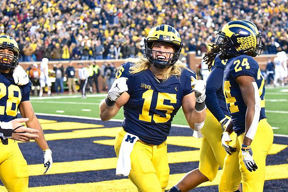 Brandon Watson (28), Chase Winovich (15), Devin Gil (36), and Lavert Hill (24)