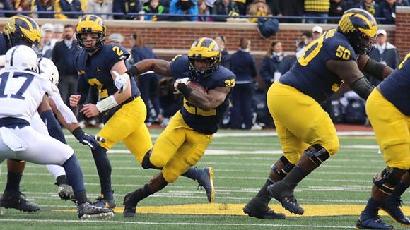 Shea Patterson (2), Karan Higdon (22), and Michael Onwenu (50)