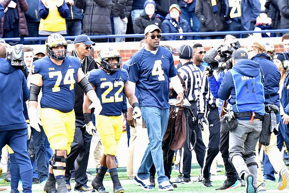 Ben Bredeson (74), Karan Higdon (22), and Chris Webber