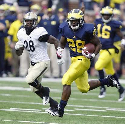 Fitzgerald Toussaint (28) and Denard Robinson (16)