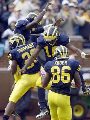 Devin Gardner (7), Fitzgerald Toussaint (28), Kevin Koger (86),  and Denard Robinson (16)