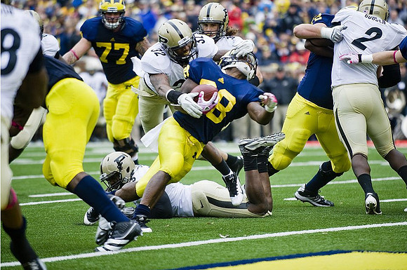 Taylor Lewan (77), Fitzgerald Toussaint (28), and Mark Huyge (72)