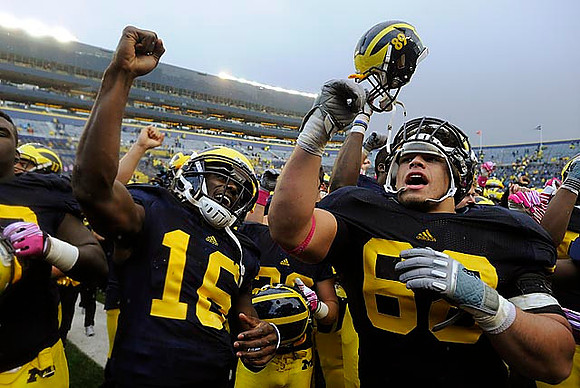 Denard Robinson (16) and Mike Martin (68)