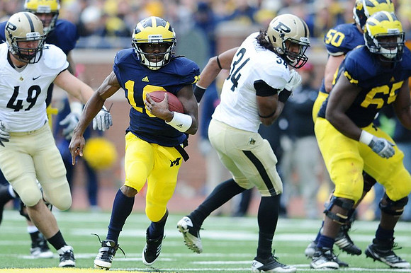 Denard Robinson (16), Patrick Omameh (65), and David Molk (50)